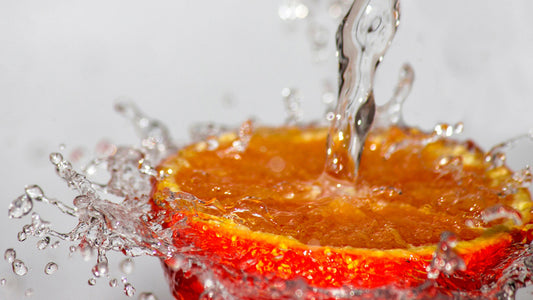 Half an orange being splashed with water