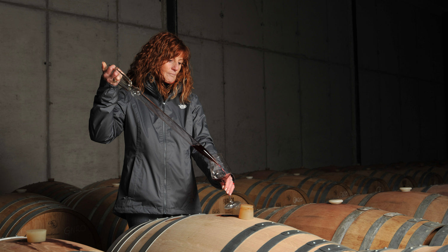 Spanish winemaker Rosalía Molina tests wine from a barrel in the Spanish winery of Altolandon